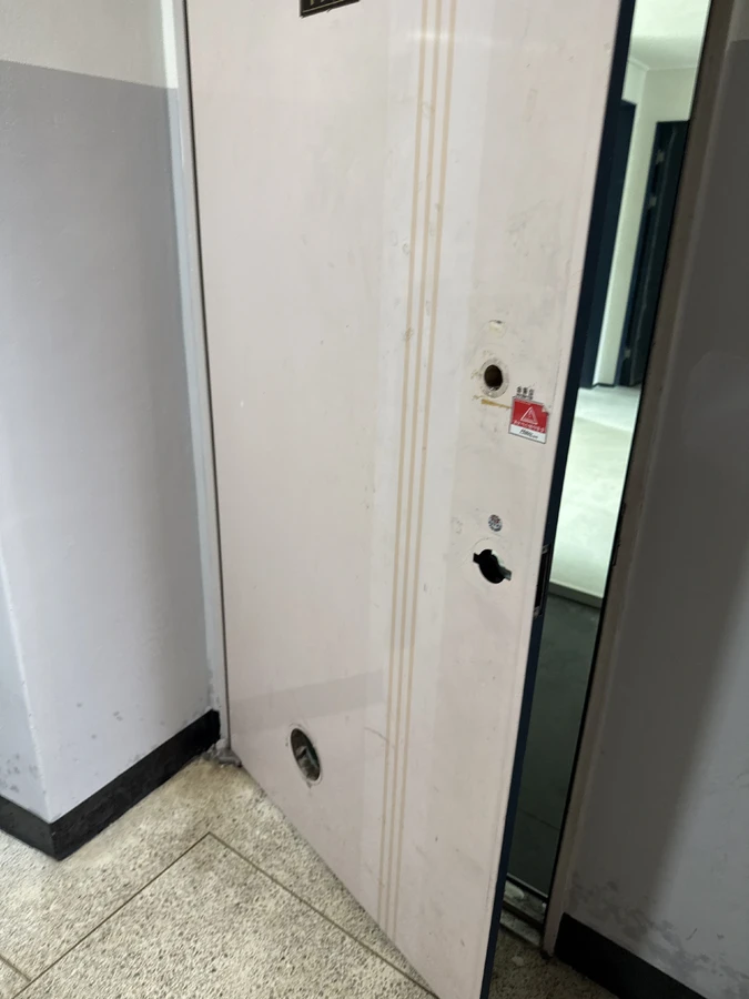 강남 아파트 철문 시공 전, 보조 잠금장치를 떼어낸 구멍과 벗겨진 도장면